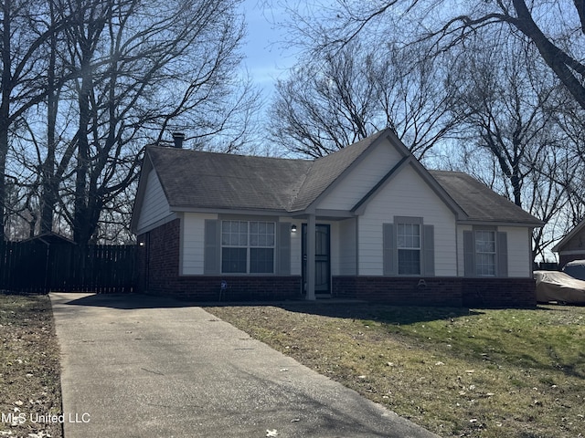 single story home with fence, a front lawn, and brick siding