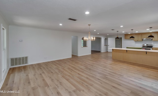 551 Holly Bush Rd, Brandon, MS 39047 - unfurnished living room with recessed lighting, light wood finished floors, a chandelier, baseboards, and arched walkways