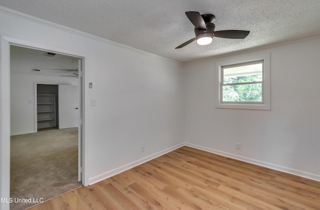 551 Holly Bush Rd, Brandon, MS 39047 - unfurnished room with a textured ceiling, light wood-style floors, ornamental molding, baseboards, and ceiling fan