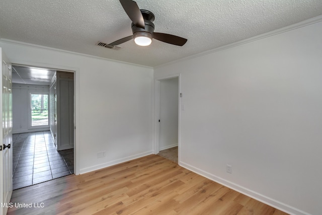 551 Holly Bush Rd, Brandon, MS 39047 - empty room with crown molding, ceiling fan, light wood-type flooring, a textured ceiling, and attic access