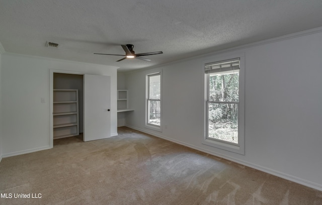 551 Holly Bush Rd, Brandon, MS 39047 - unfurnished bedroom with a textured ceiling, carpet floors, crown molding, baseboards, and a ceiling fan