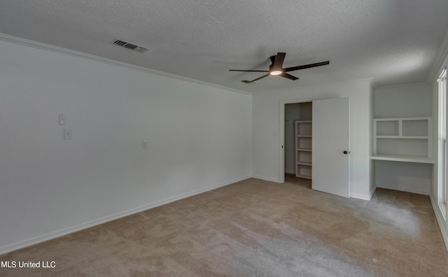 551 Holly Bush Rd, Brandon, MS 39047 - unfurnished bedroom with a textured ceiling, light carpet, a closet, baseboards, and a ceiling fan