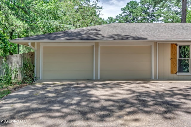 551 Holly Bush Rd, Brandon, MS 39047 - garage with asphalt driveway and fence