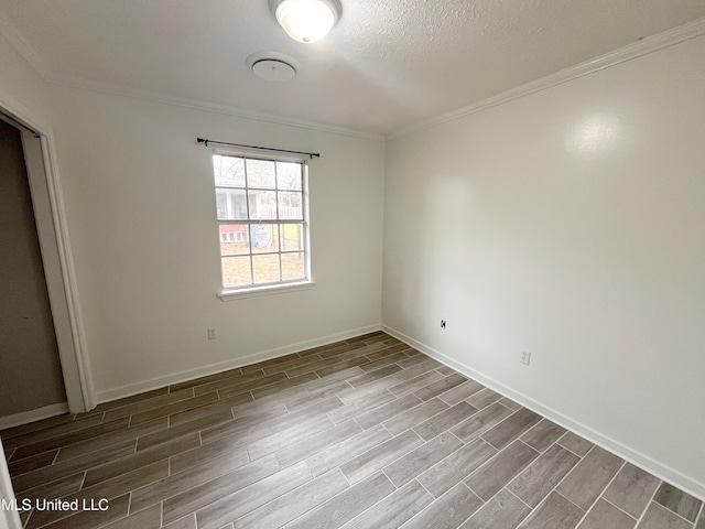 unfurnished room featuring wood-type flooring, a textured ceiling, and crown molding