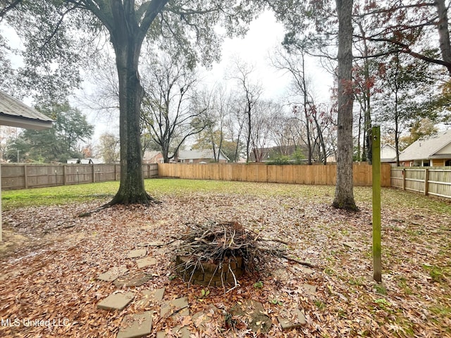 view of yard with an outdoor fire pit