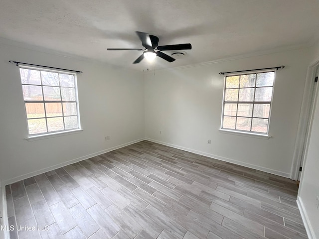 unfurnished room with ceiling fan, plenty of natural light, and light wood-type flooring