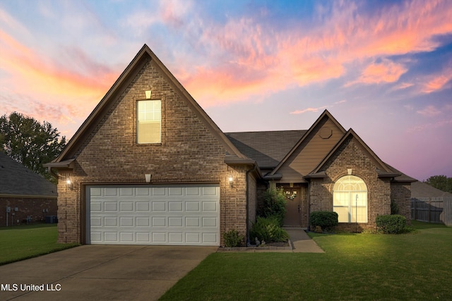 view of front of property with a lawn and a garage