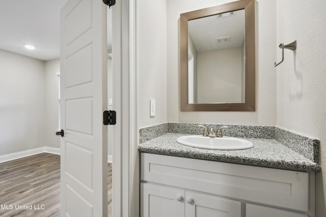 bathroom featuring vanity and wood-type flooring