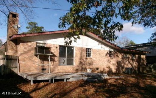 back of house with a deck