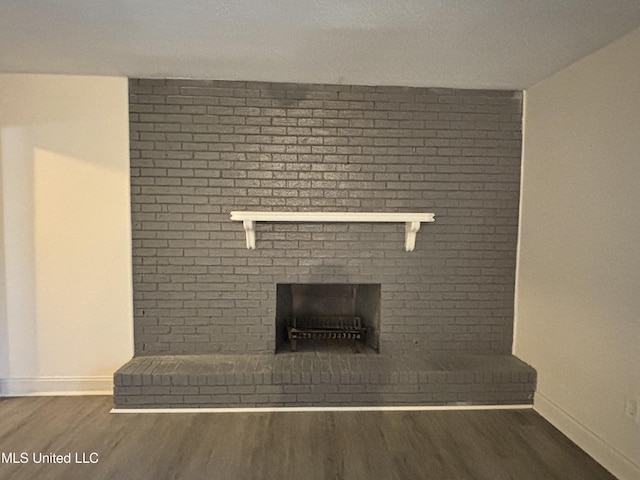 interior details with a brick fireplace and hardwood / wood-style floors