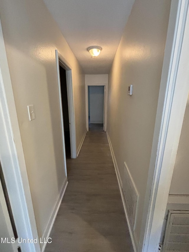 corridor with dark hardwood / wood-style floors