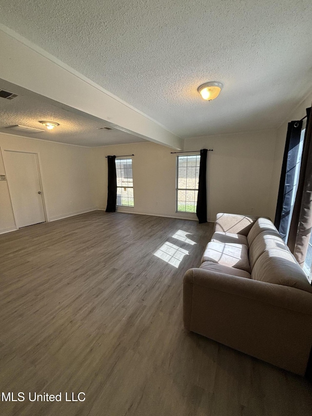 living room with hardwood / wood-style floors and a textured ceiling