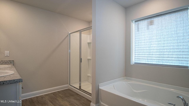 32 Crown Dr, Lucedale, MS 39452 - bathroom with a garden tub, a stall shower, double vanity, and wood finished floors