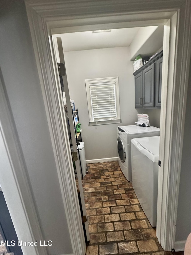 4896 Park N Dr, Olive Branch, MS 38654 - washroom featuring separate washer and dryer, cabinet space, brick floors, and baseboards