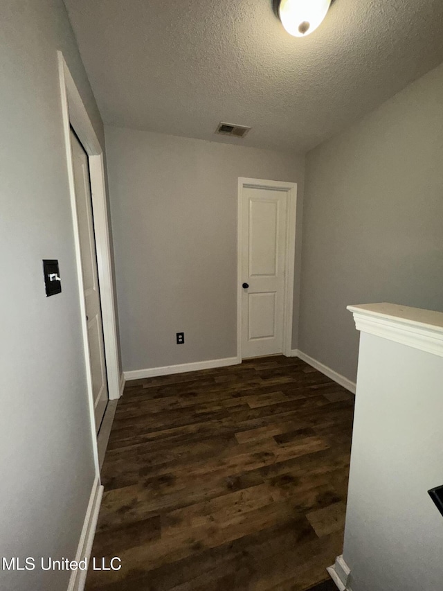4896 Park N Dr, Olive Branch, MS 38654 - spare room with dark wood finished floors, a textured ceiling, and baseboards