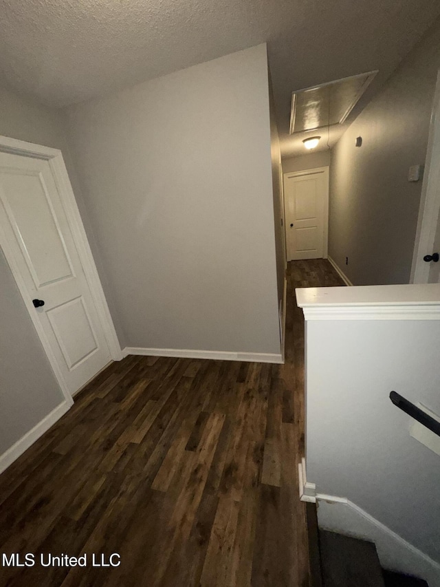 4896 Park N Dr, Olive Branch, MS 38654 - hall with attic access, dark wood-style flooring, baseboards, and a textured ceiling