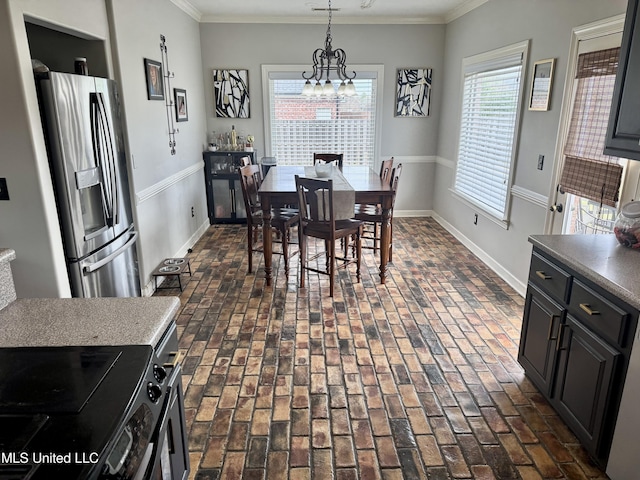 4896 Park N Dr, Olive Branch, MS 38654 - dining space featuring brick floors, crown molding, baseboards, and a chandelier
