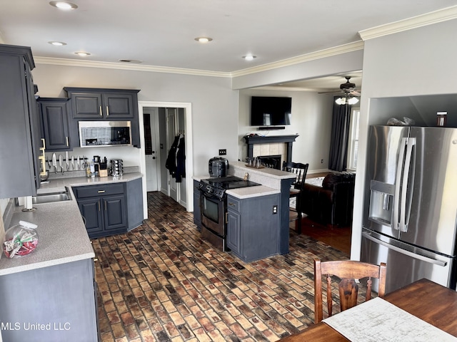 4896 Park N Dr, Olive Branch, MS 38654 - kitchen with appliances with stainless steel finishes, brick patterned flooring, ceiling fan, light countertops, and ornamental molding
