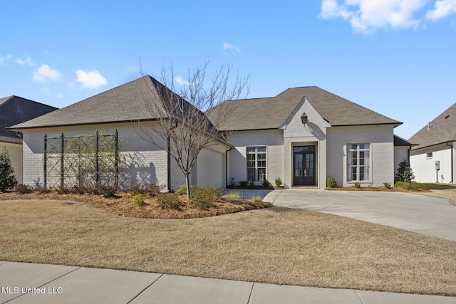 view of front of house with a front yard and a garage