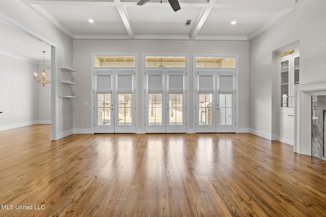 unfurnished living room with hardwood / wood-style floors, coffered ceiling, and french doors