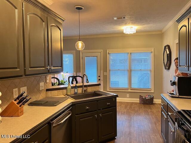 kitchen featuring sink, decorative light fixtures, stainless steel dishwasher, decorative backsplash, and crown molding