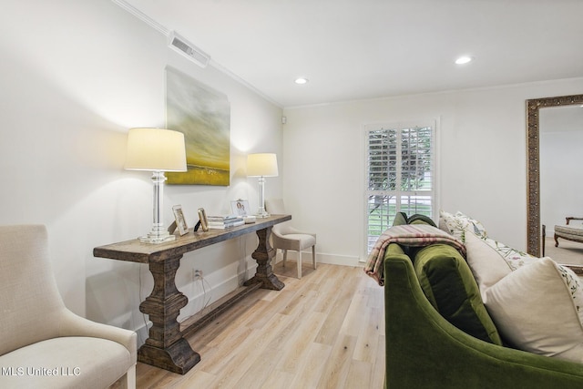 interior space with recessed lighting, baseboards, ornamental molding, visible vents, and light wood-type flooring