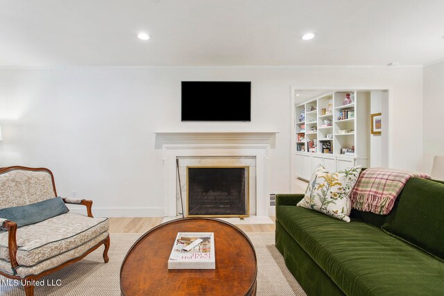 living room with light hardwood / wood-style floors and crown molding