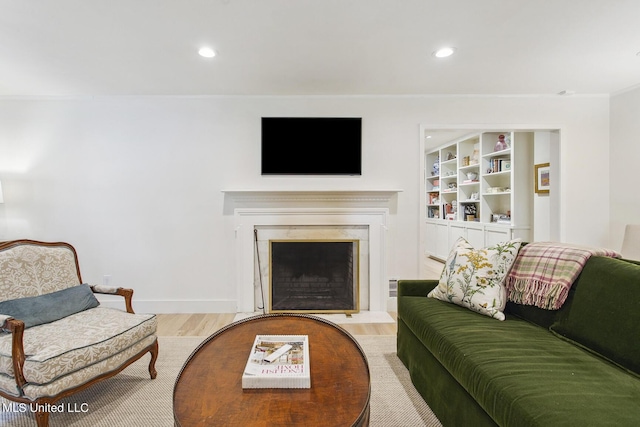 living room with a premium fireplace, recessed lighting, and wood finished floors