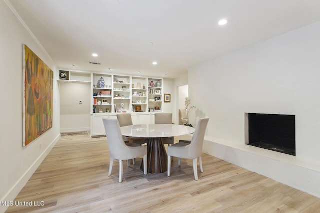 dining room with recessed lighting, visible vents, and light wood-type flooring