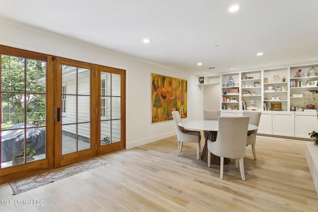 dining area featuring baseboards, light wood finished floors, and recessed lighting