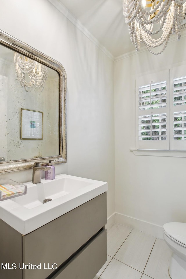 bathroom with vanity, ornamental molding, a notable chandelier, and tile patterned floors