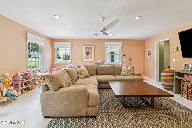 living room with a healthy amount of sunlight and ceiling fan