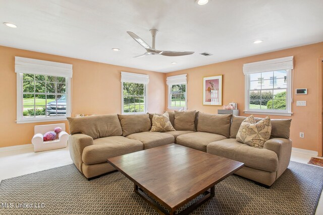 living room featuring ceiling fan, carpet, and plenty of natural light