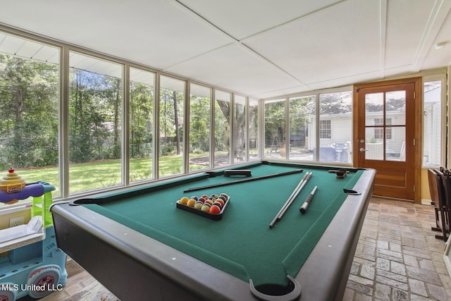 game room featuring billiards, brick floor, and plenty of natural light