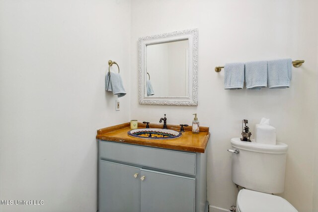 bathroom with toilet and vanity