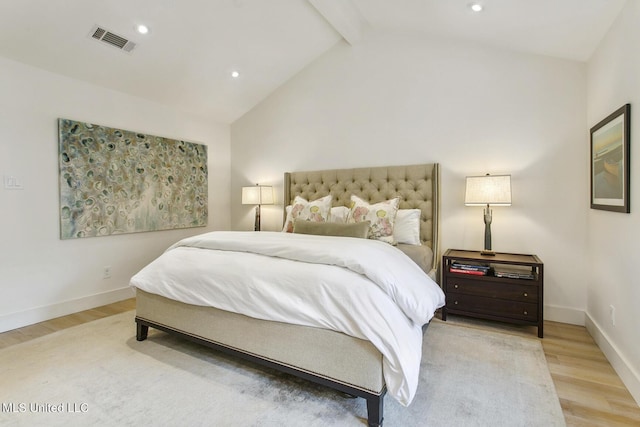 bedroom featuring vaulted ceiling with beams, baseboards, visible vents, and wood finished floors