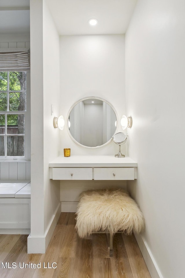 bathroom featuring baseboards, recessed lighting, and wood finished floors
