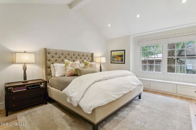 bedroom featuring vaulted ceiling with beams and hardwood / wood-style floors