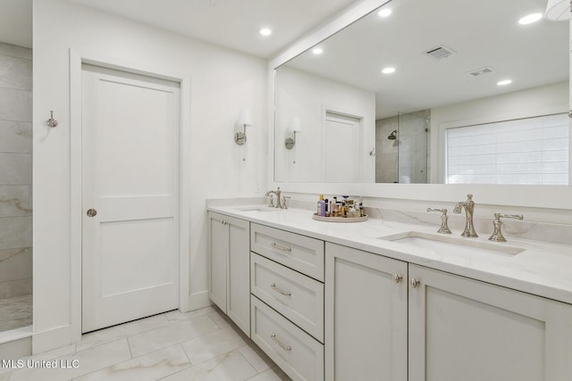 bathroom with a stall shower, visible vents, a sink, and double vanity