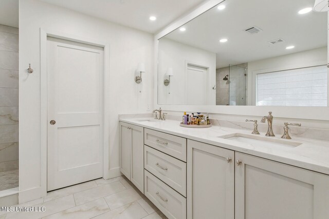 bathroom with vanity and tiled shower