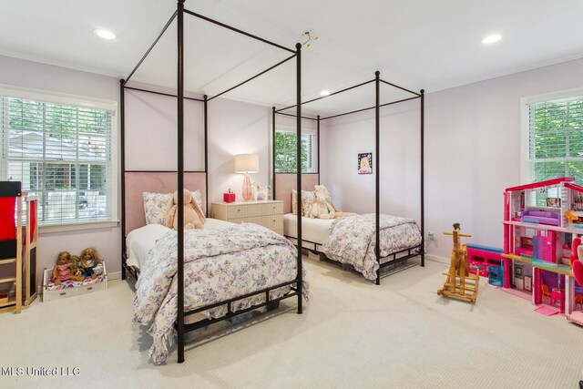 carpeted bedroom with multiple windows