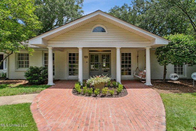 view of front of property with french doors and a porch