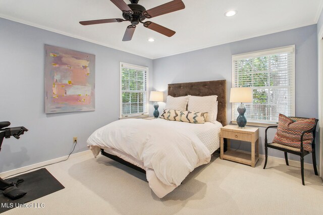 carpeted bedroom featuring ceiling fan, crown molding, and multiple windows