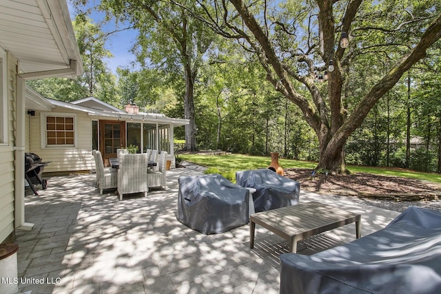 view of patio with outdoor dining area and a grill