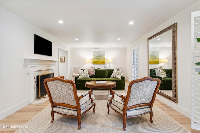 interior space featuring ornamental molding and light hardwood / wood-style floors