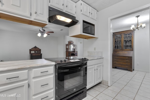 kitchen with light tile patterned flooring, light countertops, under cabinet range hood, white cabinets, and black appliances