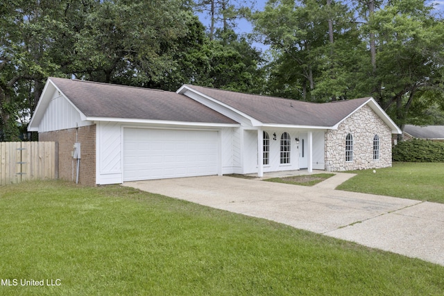 single story home with a garage, fence, a front yard, brick siding, and driveway