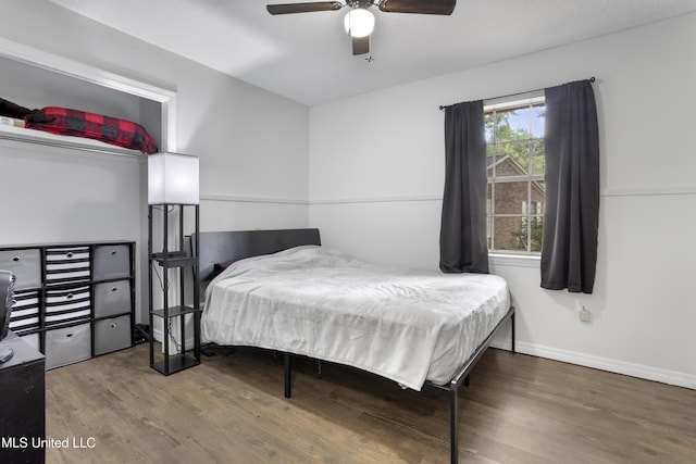 bedroom with baseboards, ceiling fan, and wood finished floors