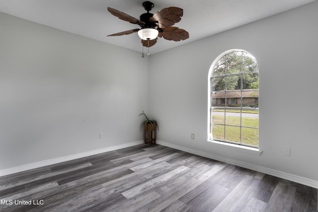 empty room with baseboards, a ceiling fan, and wood finished floors