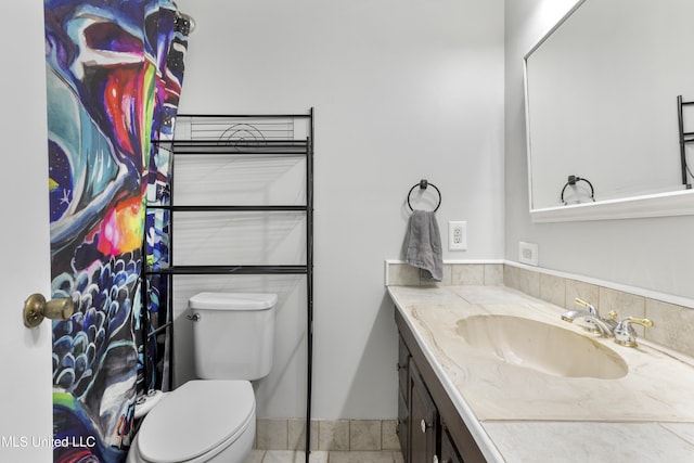 bathroom with toilet and vanity